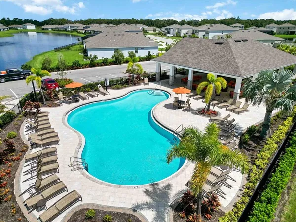 an aerial view of a house with outdoor space and lake view