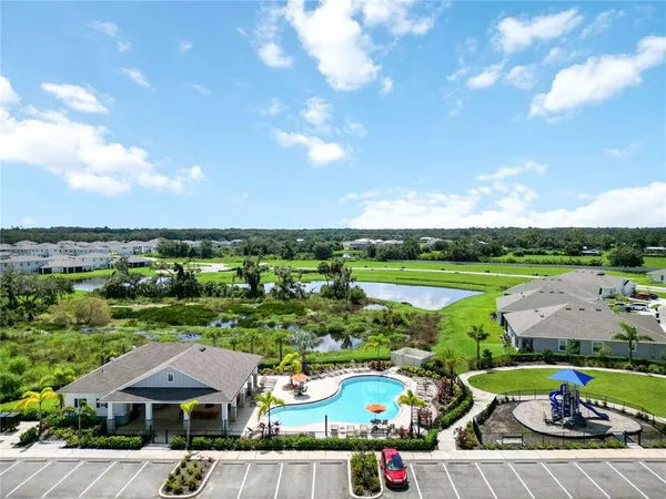 a view of a house with swimming pool and furniture
