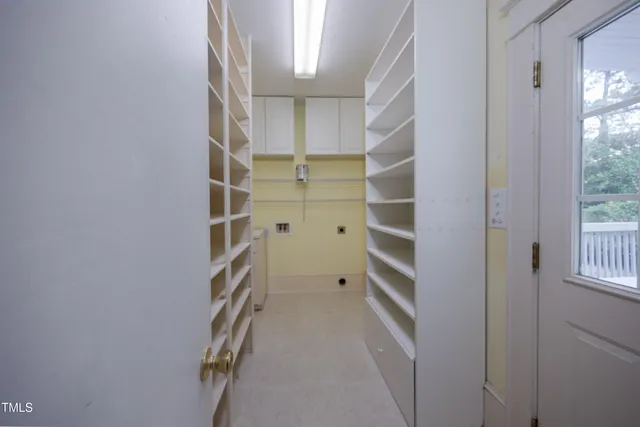 a view of walk in closet with empty racks