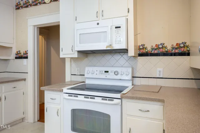a view of washer and dryer with kitchen in the background