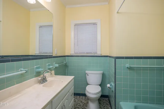 a bathroom with a sink toilet and mirror