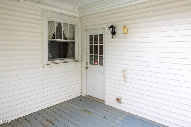 a view of front door and deck of the house