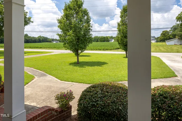 a view of a garden with a building in the background