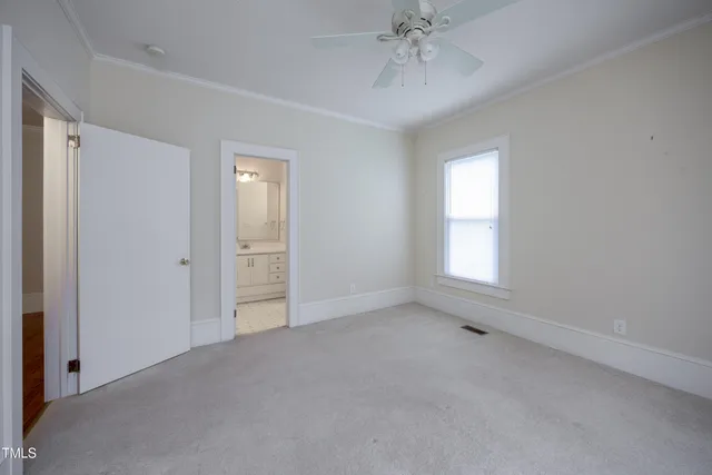 an empty room with a empty space and windows