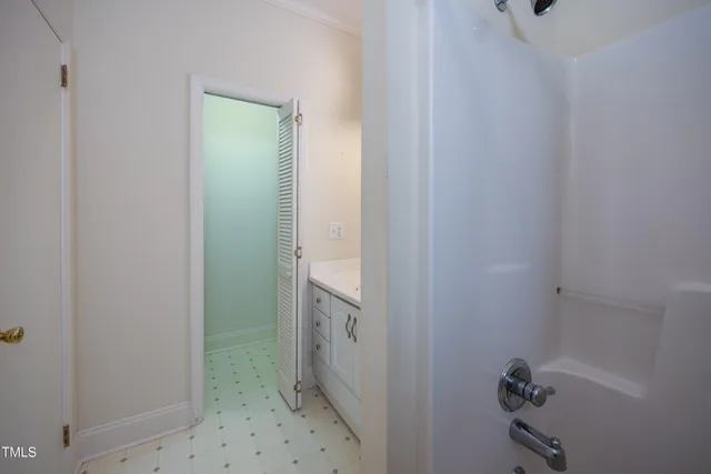 a bathroom with a granite countertop sink