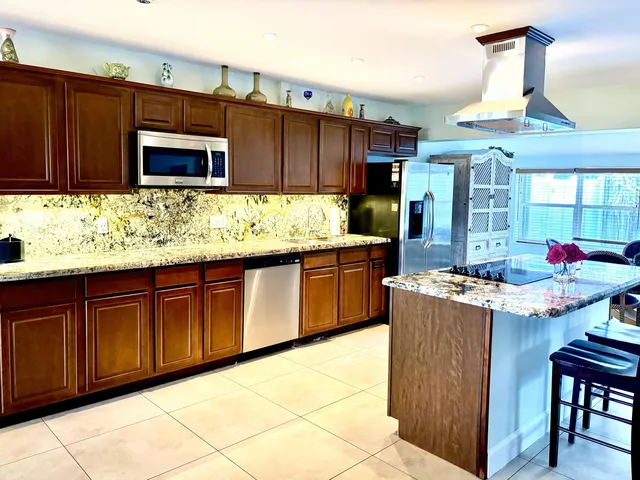 a kitchen with granite countertop a sink and cabinets