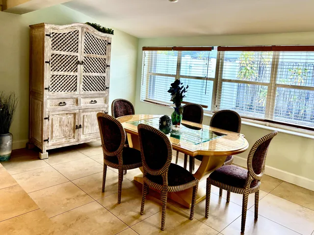 a dining room with furniture and window