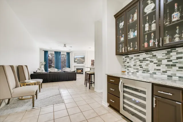 a living room with furniture a fireplace and a table
