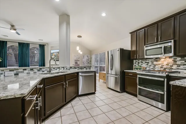 a view of a dining room with furniture and chandelier