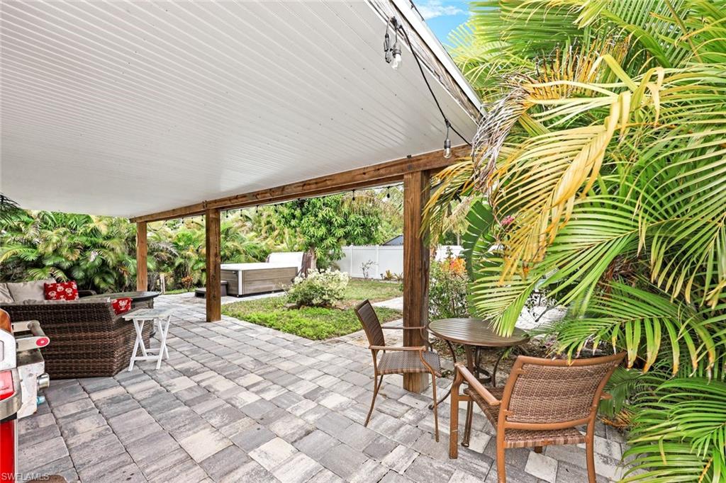 645 101st Avenue North Naples, FL 34108 - Photo 18 of 24 a backyard of a house with yard and outdoor seating