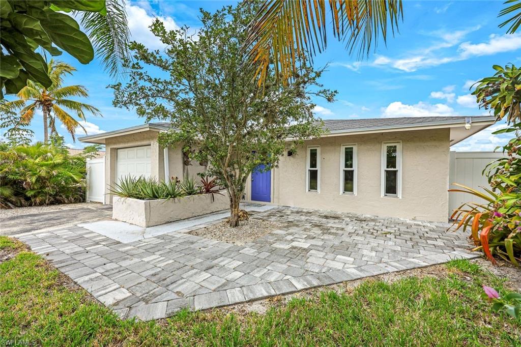 645 101st Avenue North Naples, FL 34108 - Photo 2 of 24 a view of a house with a yard and potted plants