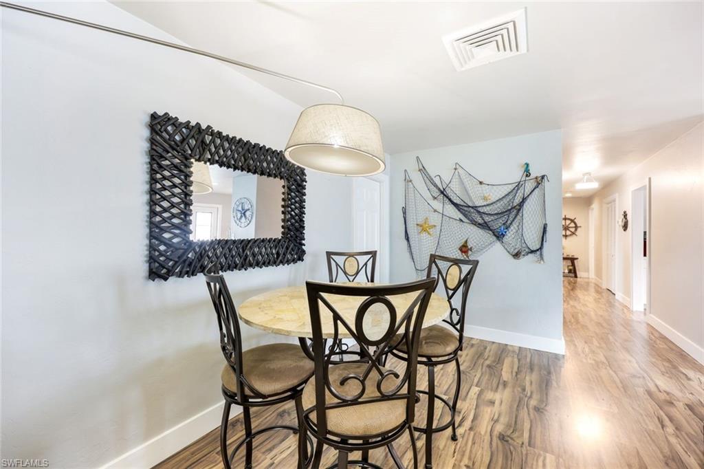 645 101st Avenue North Naples, FL 34108 - Photo 6 of 24 a view of a chairs and table in a kitchen