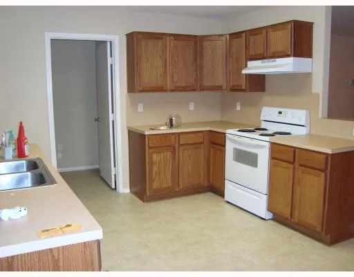 a kitchen that has a sink and a stove in it