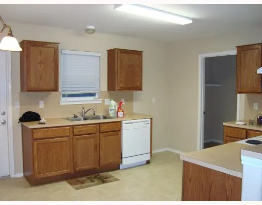 a kitchen with a sink cabinets and wooden floor