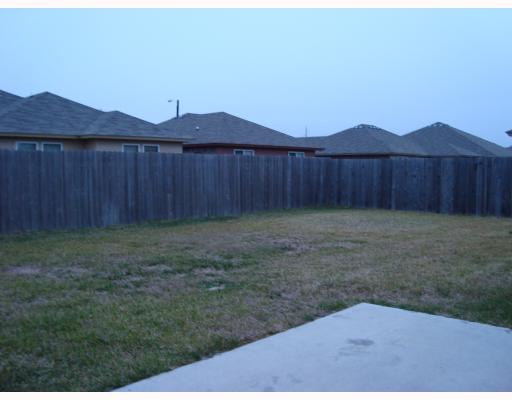1519 Windy Oaks Drive Aransas Pass, TX 78336 - Photo 9 of 10 a view of a backyard with a small cabin and wooden fence