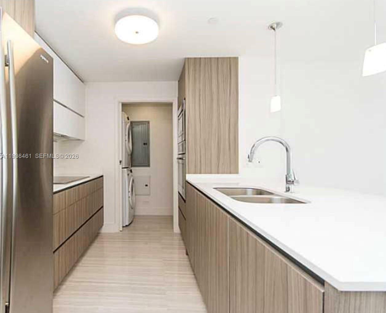 600 Northeast 27th Street, Unit 2004 Miami, FL 33137 - Photo 4 of 9 a kitchen with a sink and a refrigerator