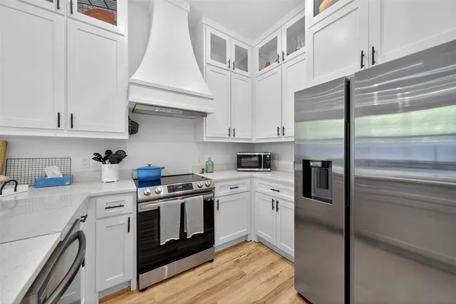a kitchen with stainless steel appliances granite countertop a stove and a refrigerator
