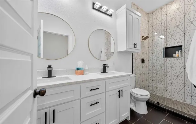 a bathroom with a toilet sink and mirror