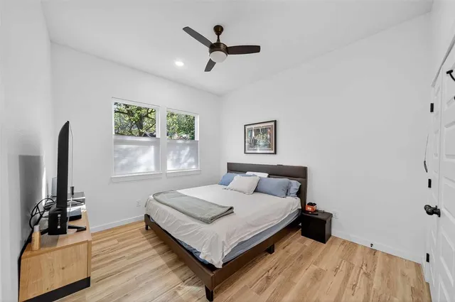 a bedroom with a bed and a flat screen tv