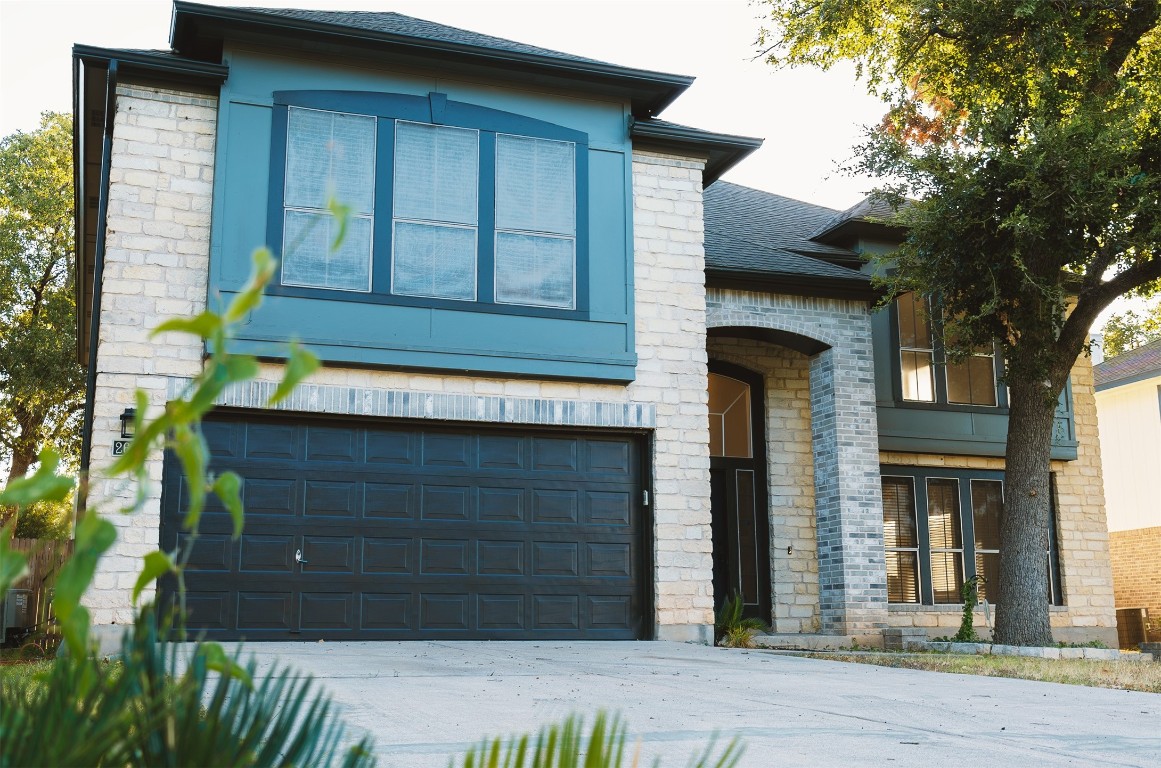 a front view of a house with a garage