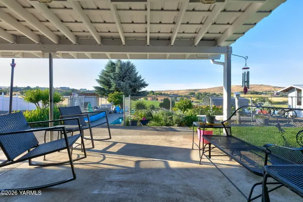 a view of a patio with couches table and chairs with wooden floor and plants