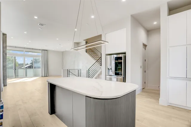 a view of kitchen with furniture and refrigerator