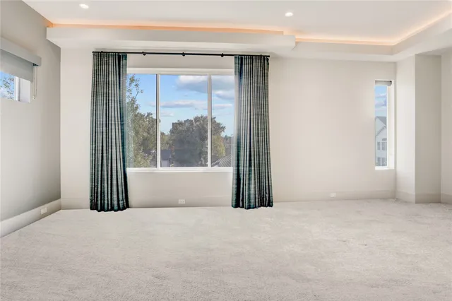 a bedroom with a balcony a bed and a television