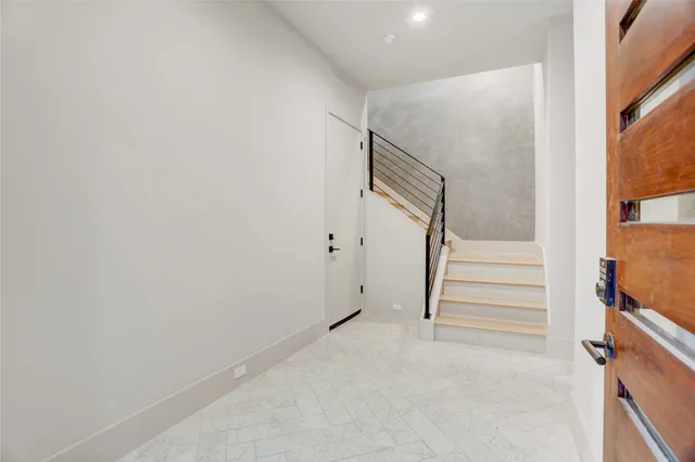 a view of entryway with stairs and white walls