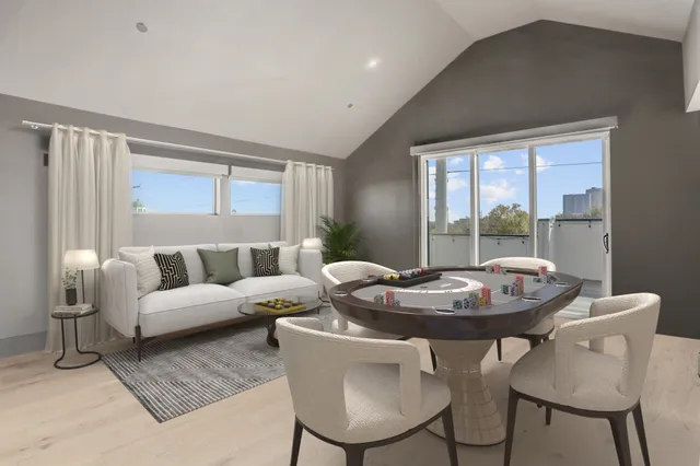 a view of a balcony kitchen island and stainless steel appliances