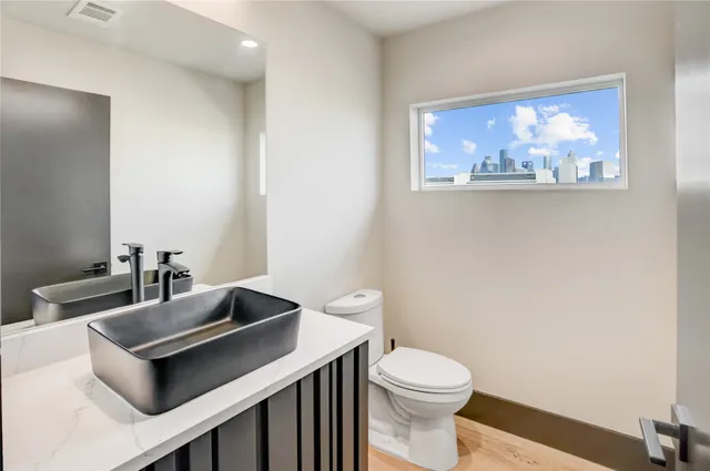 a kitchen with stainless steel appliances granite countertop a sink a stove and a refrigerator