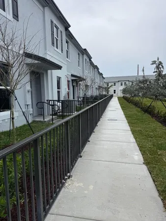 a view of a house with wooden fence