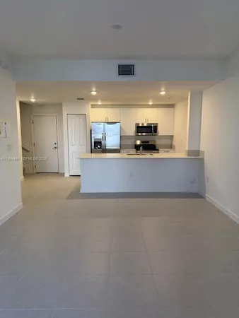 a view of a kitchen with a sink and a window