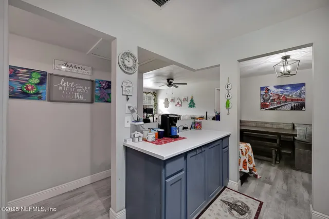 a kitchen with a refrigerator and a stove top oven