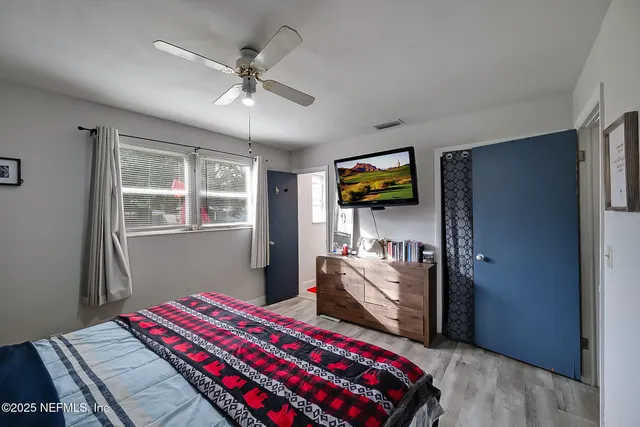 a bedroom with bed and a window