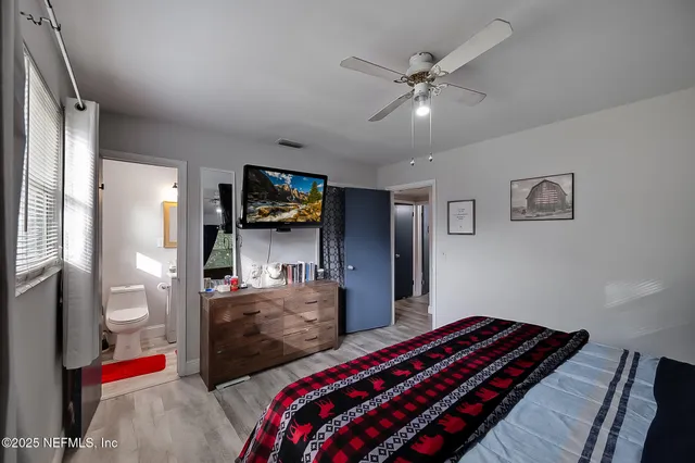 a bedroom with bed and window