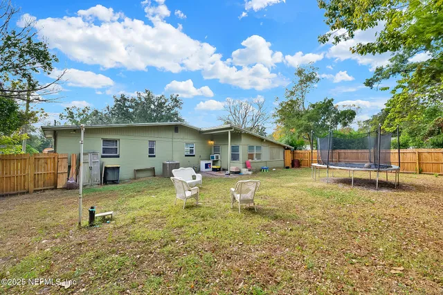 a view of a house with backyard porch and sitting area