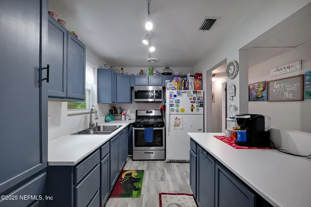 a kitchen with refrigerator and cabinets