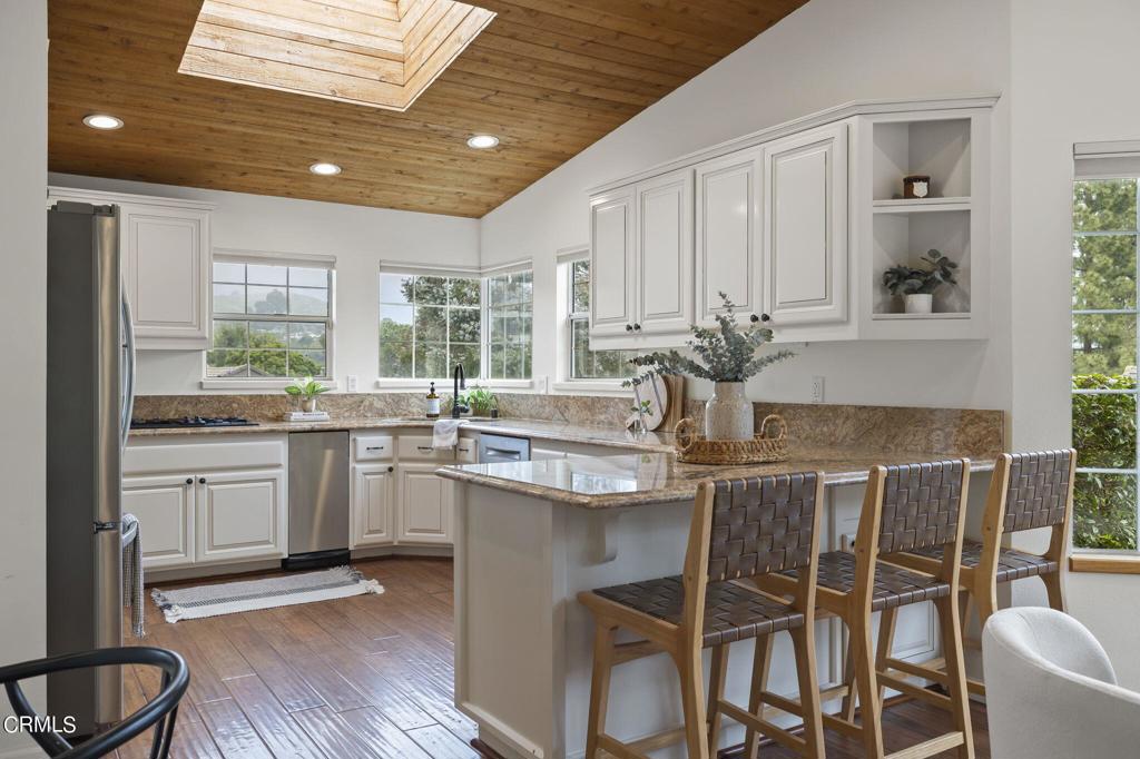116 Via Pasito Ventura, CA 93003 - Photo 21 of 61 a kitchen with stainless steel appliances granite countertop a kitchen island hardwood floor sink stove and dining table