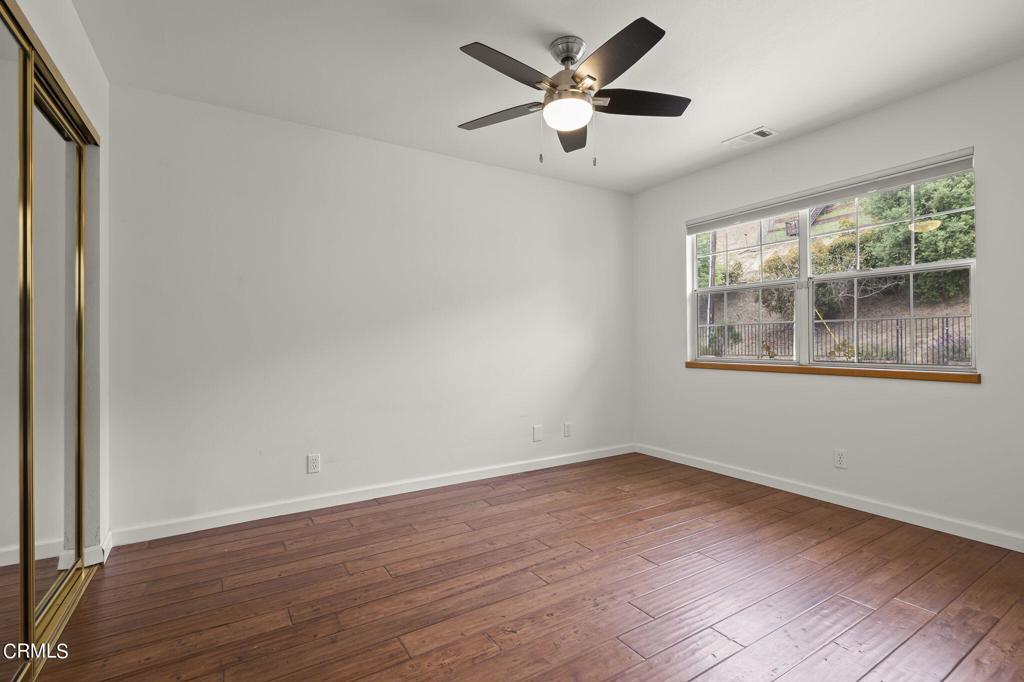 116 Via Pasito Ventura, CA 93003 - Photo 39 of 61 a view of an empty room with wooden floor and a window