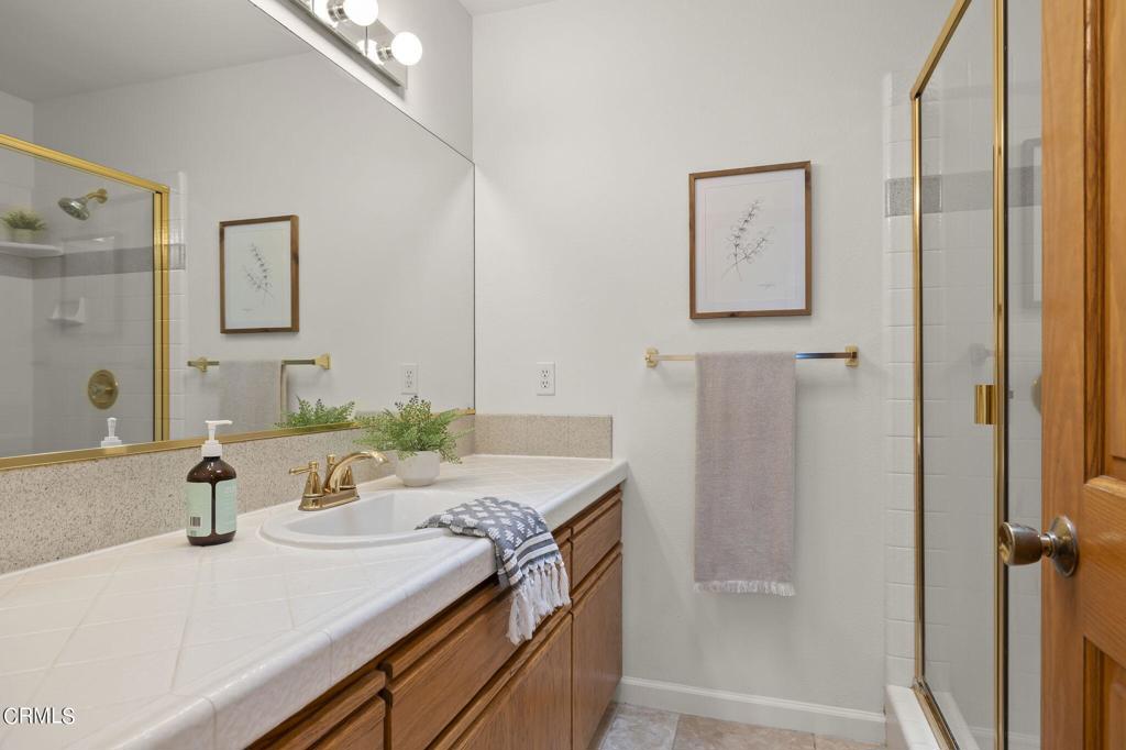 116 Via Pasito Ventura, CA 93003 - Photo 41 of 61 a bathroom with a granite countertop sink and a mirror