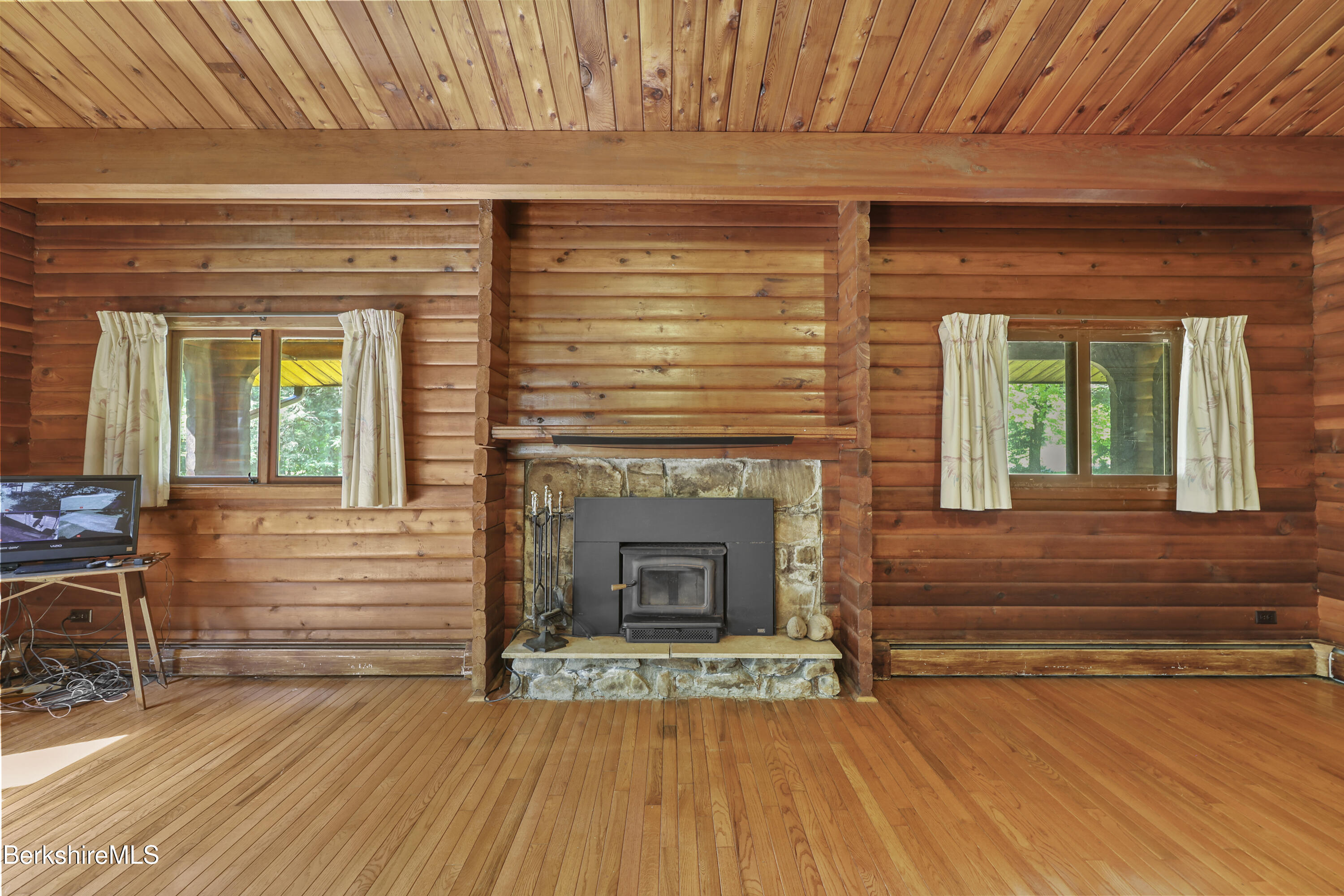 240 Kirchner Road Dalton, MA 01226 - Photo 13 of 51 an empty room with wooden floor a fireplace and windows