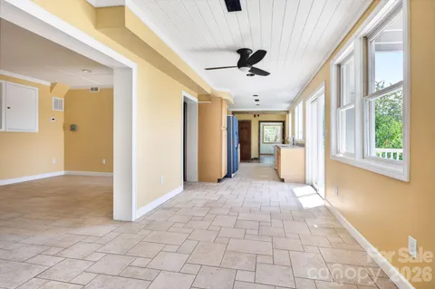 a view of hallway with window and a livingroom