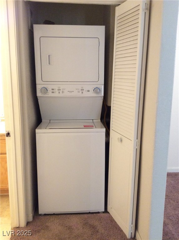 3318 North Decatur Boulevard, Unit 2077 Las Vegas, NV 89130 - Photo 14 of 19 Laundry area with stacked washer and clothes dryer and carpet