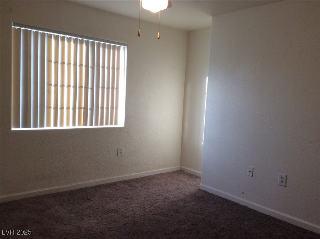 3318 North Decatur Boulevard, Unit 2077 Las Vegas, NV 89130 - Photo 15 of 19 Empty room featuring plenty of natural light and carpet