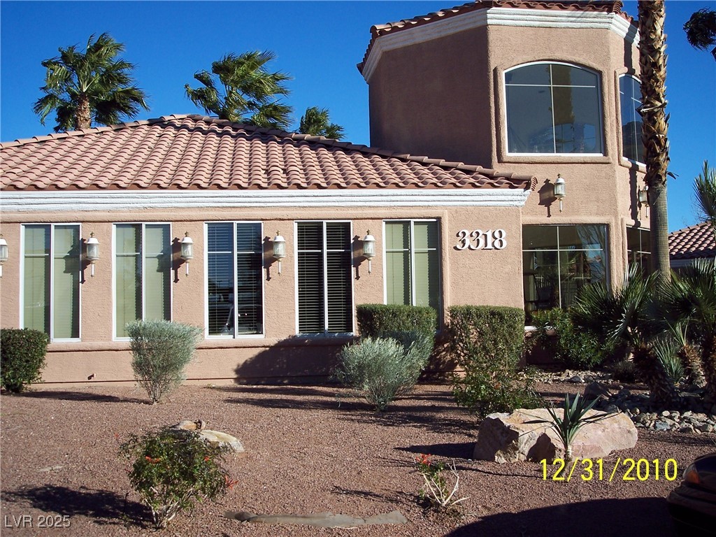 3318 North Decatur Boulevard, Unit 2077 Las Vegas, NV 89130 - Photo 3 of 19 Back of house with a tile roof and stucco siding