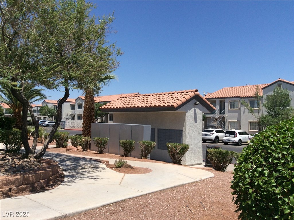 3318 North Decatur Boulevard, Unit 2077 Las Vegas, NV 89130 - Photo 7 of 19 Mediterranean / spanish-style home with stucco siding, a tile roof, and a residential view