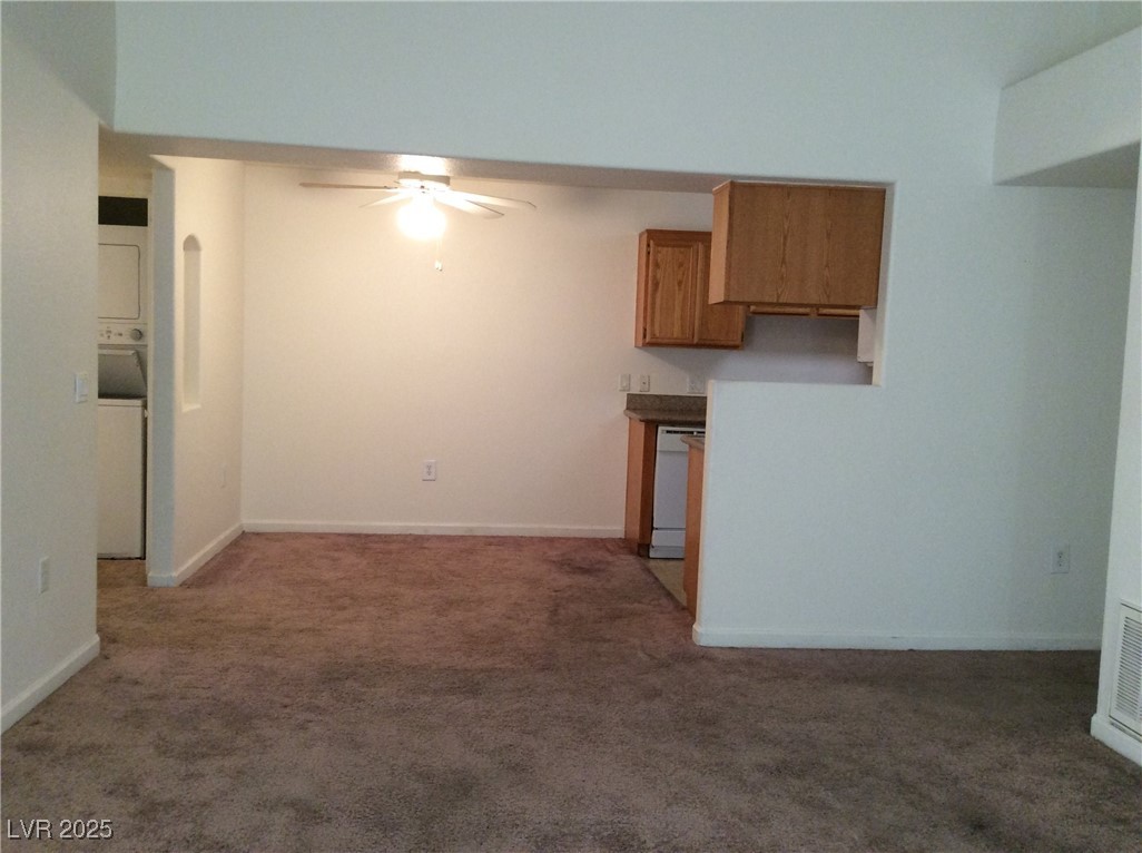 3318 North Decatur Boulevard, Unit 2077 Las Vegas, NV 89130 - Photo 10 of 19 Unfurnished living room with ceiling fan and light carpet