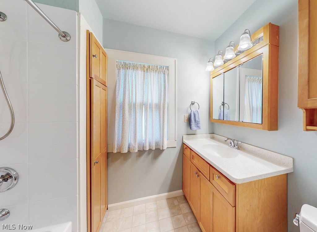 3189 Chadbourne Road Cleveland, OH 44120 - Photo 21 of 25 Full bathroom with tile floors, tiled shower / bath combo, toilet, and oversized vanity