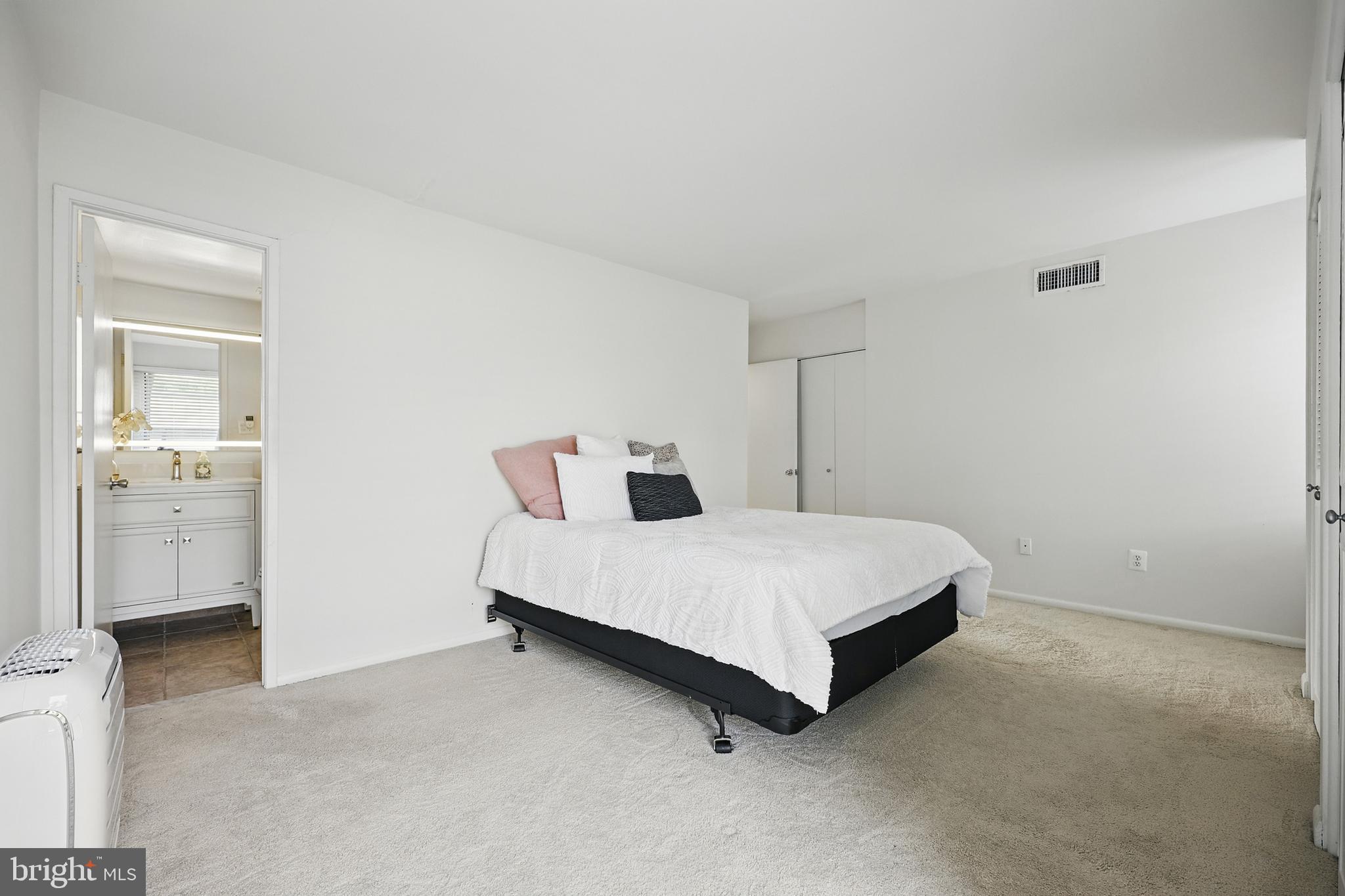 2107 Walsh View Terrace, Unit 14301 & 304 Silver Spring, MD 20902 - Photo 23 of 54 a room with a bed and a closet