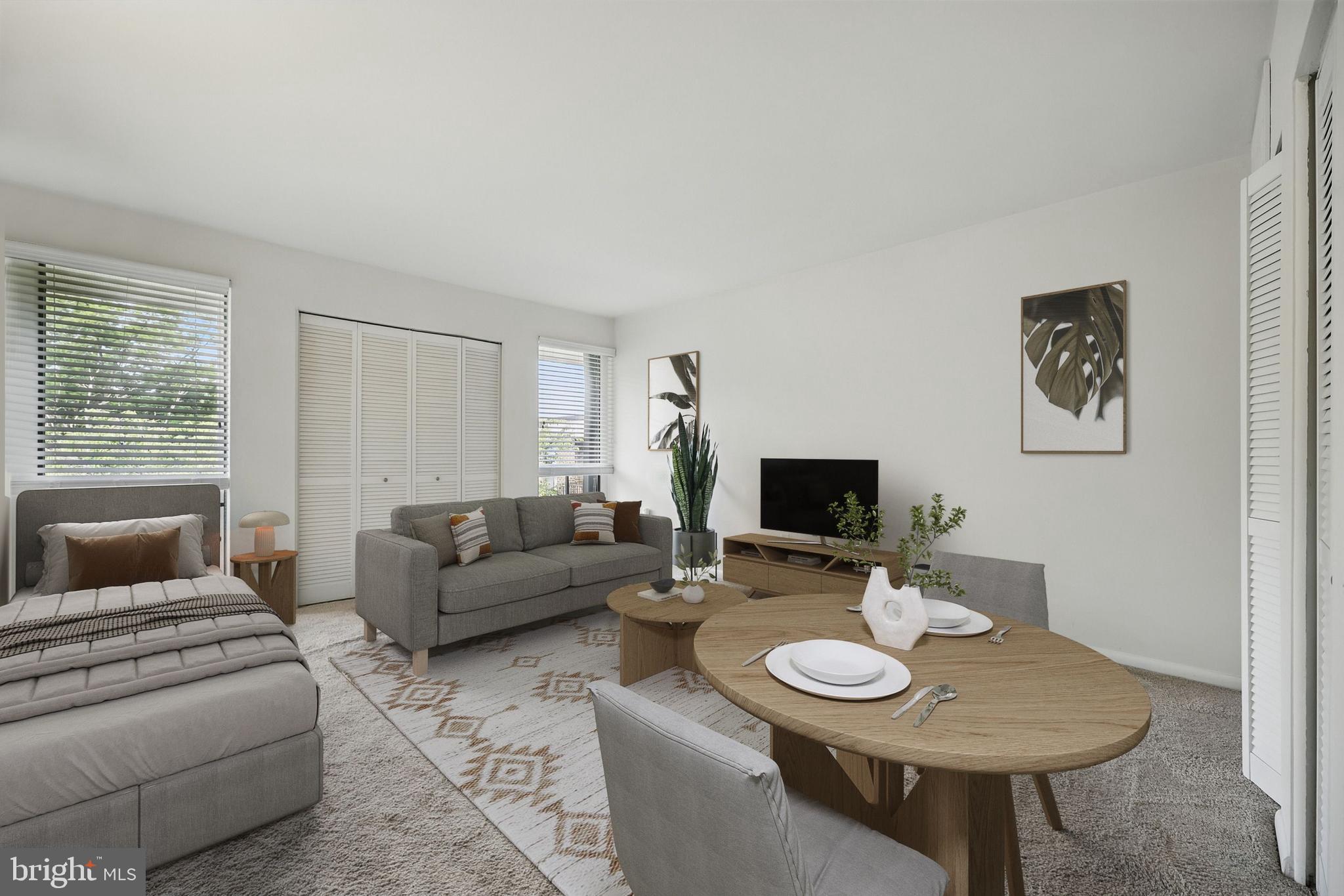 2107 Walsh View Terrace, Unit 14301 & 304 Silver Spring, MD 20902 - Photo 26 of 54 a living room with furniture and a flat screen tv